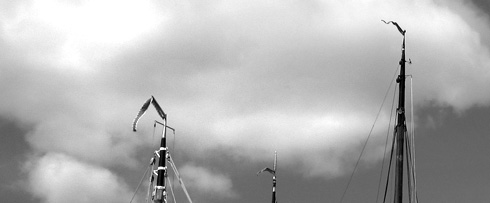 Pennants flying on masts of boats at Governor's Island, Harbor Day
